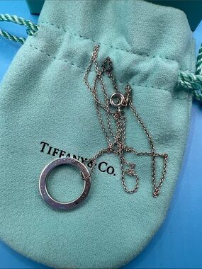 Tiffany & Co. Silver Circle Pendant Necklace on Blue-Green Pouch and box